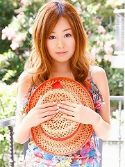 Red headed asian cutie posing in a floral printed dress